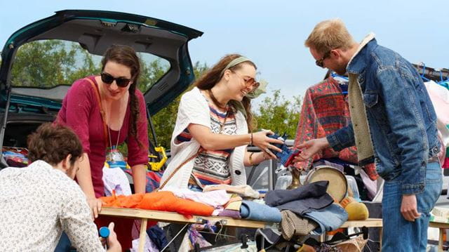 How to do a car boot sale woman smiling at car boot sale